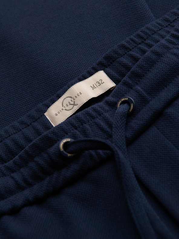 Ombre Clothing Moške hlače iz piqué pletenine z nastavljivo pasom - temno modre V1 OM-PACP-0283 Ombre Clothing